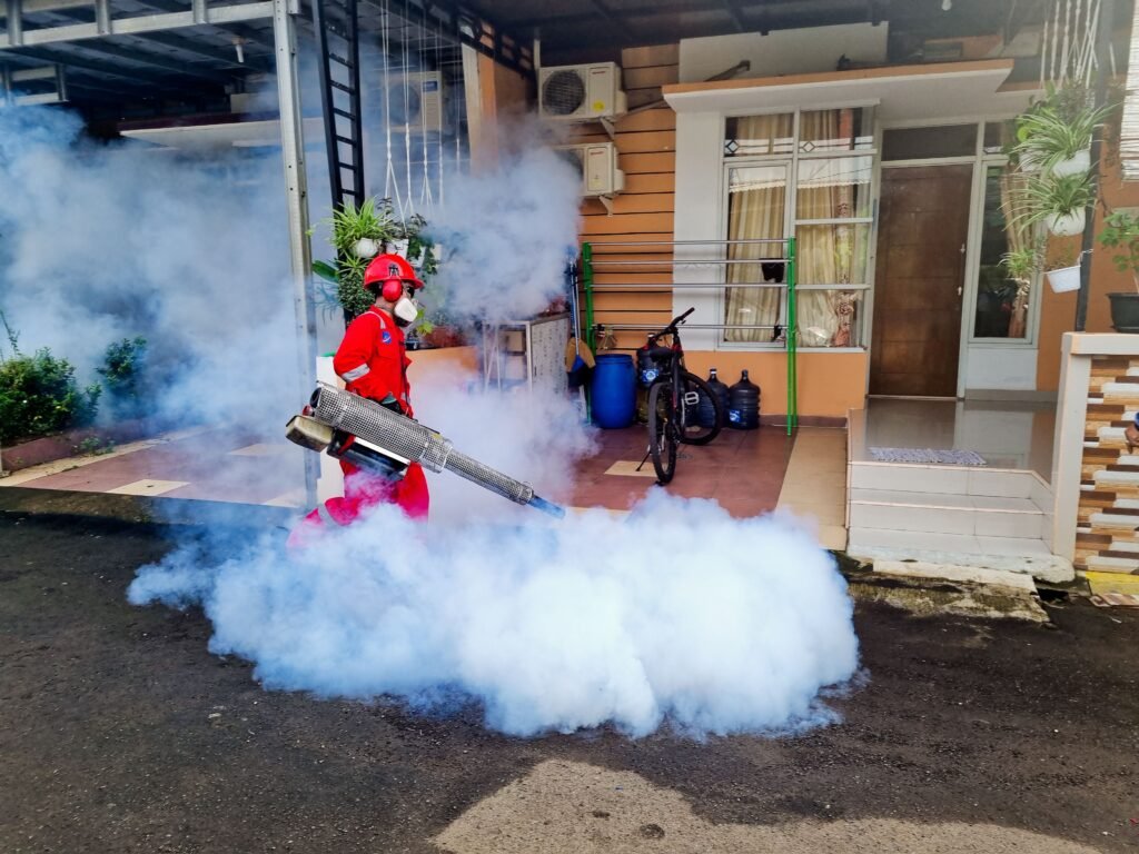 Pest control technician treating a home's foundation as part of pest control marketing services