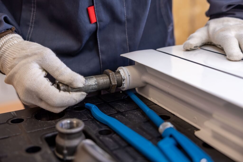 Licensed plumber repairing a kitchen sink as part of plumbing marketing services