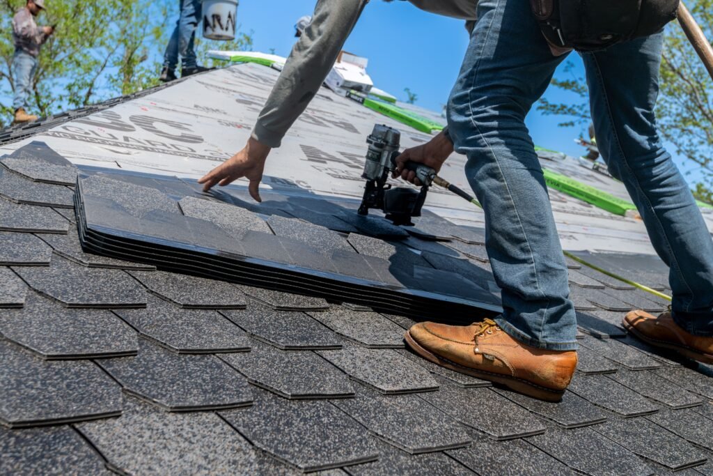 Roofing crew installing new shingles as part of roofing marketing services