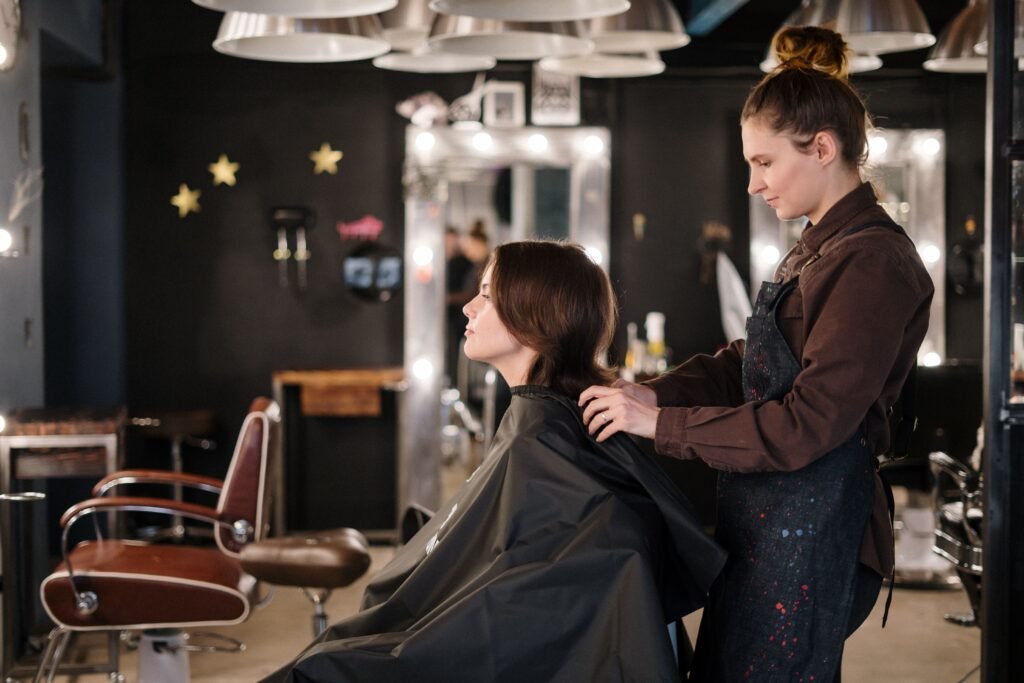 Salon stylist working with a client as part of salon and spa marketing services