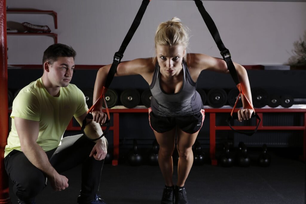 Fitness instructor guiding a client through a workout as part of fitness studio and gym marketing services