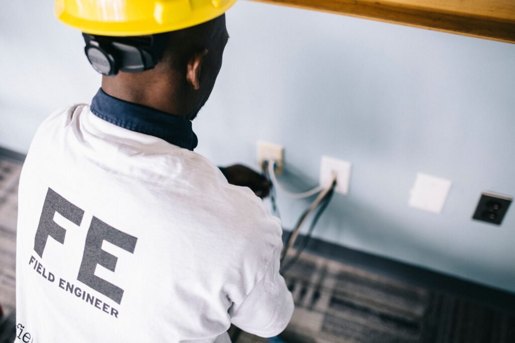 Electrician repairing an electrical panel as part of electrician marketing services