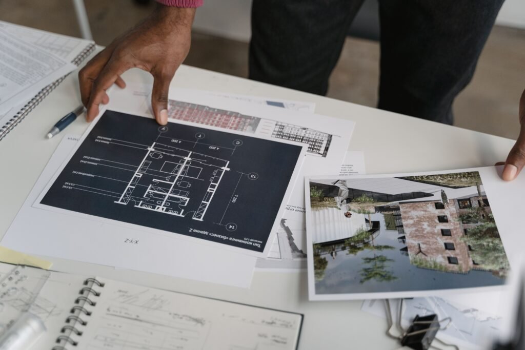 General contractor reviewing renovation plans on-site as part of remodeling marketing services